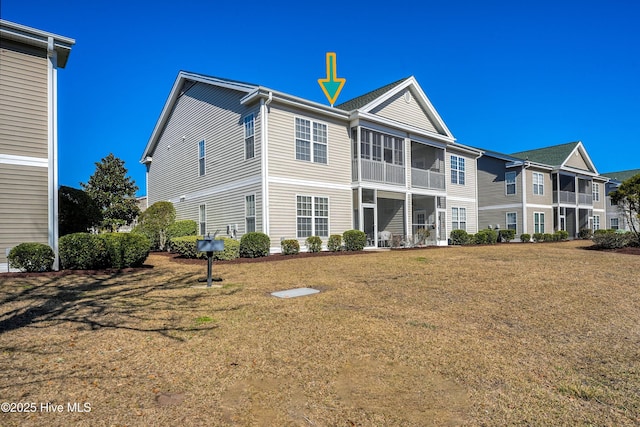 back of house featuring a lawn