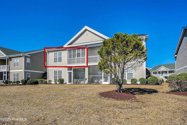 view of front of house featuring a front yard and a sunroom