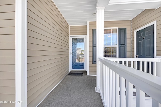 view of exterior entry featuring covered porch