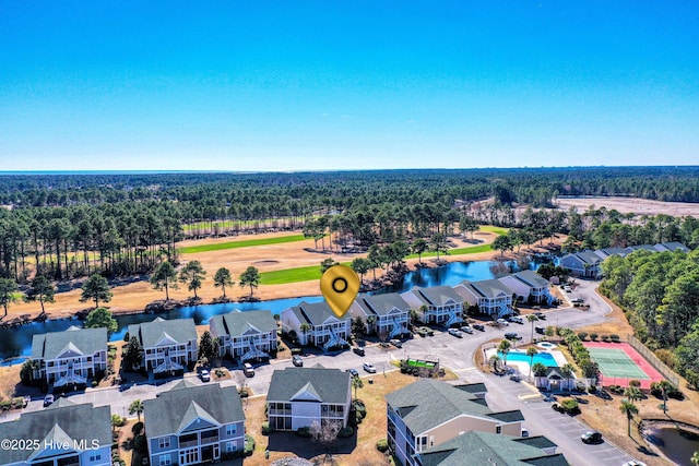 drone / aerial view with a water view and a residential view