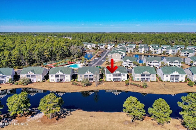 drone / aerial view featuring a residential view and a water view