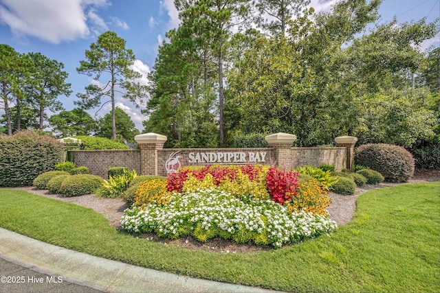 community / neighborhood sign with a lawn