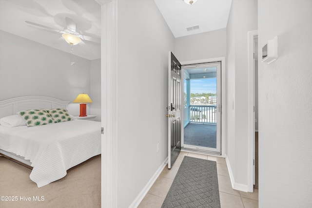 doorway to outside featuring light tile patterned floors, baseboards, visible vents, and ceiling fan