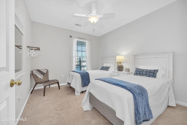 bedroom featuring a ceiling fan, light carpet, visible vents, and baseboards