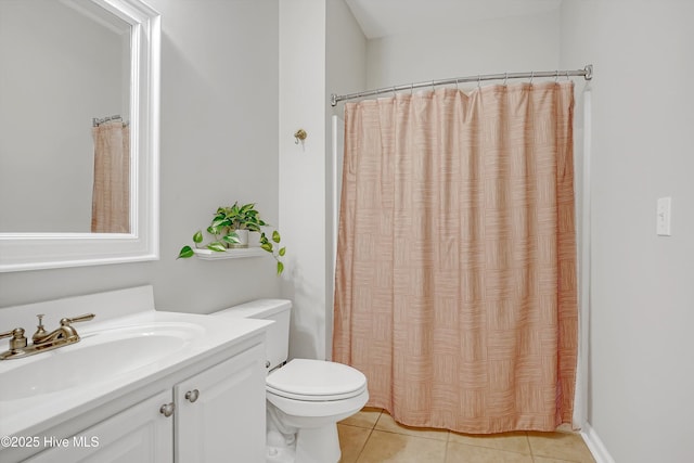 bathroom featuring tile patterned flooring, curtained shower, vanity, and toilet