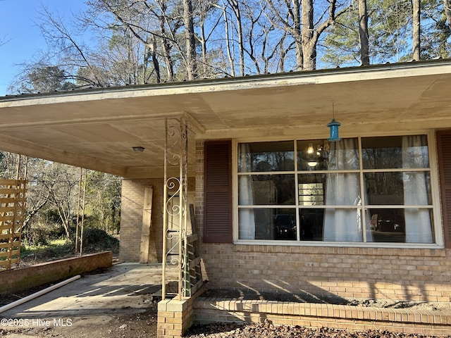 exterior space with brick siding and driveway