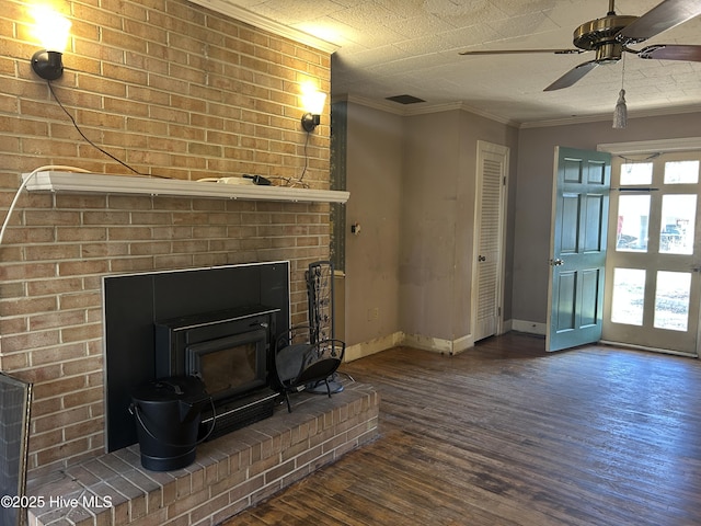 unfurnished living room featuring a ceiling fan, baseboards, wood finished floors, and ornamental molding