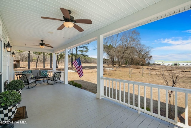 wooden deck featuring a ceiling fan and a playground