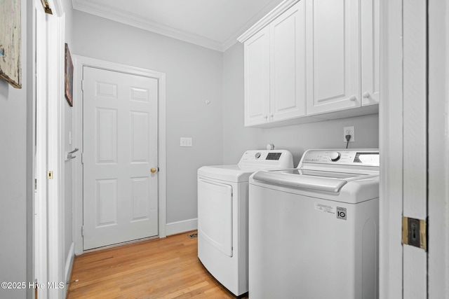 washroom featuring crown molding, cabinet space, separate washer and dryer, light wood-type flooring, and baseboards