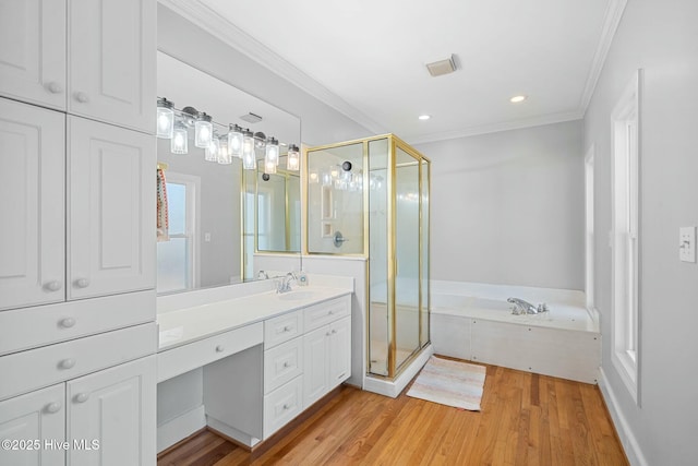 full bath featuring wood finished floors, a garden tub, crown molding, vanity, and a shower stall