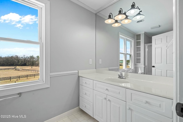 bathroom with crown molding, visible vents, vanity, baseboards, and tile patterned floors