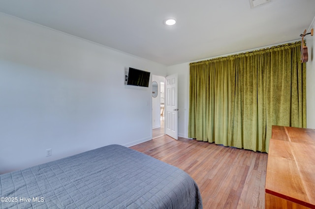 bedroom featuring visible vents, wood finished floors, and baseboards