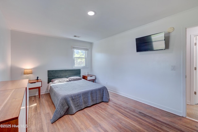 bedroom with visible vents, wood finished floors, baseboards, and recessed lighting