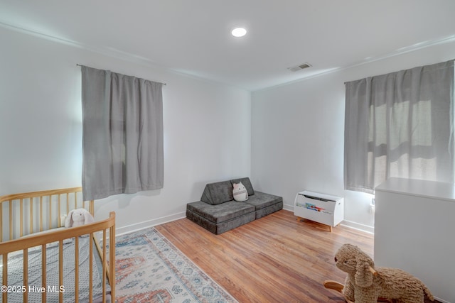 bedroom featuring baseboards, recessed lighting, visible vents, and wood finished floors
