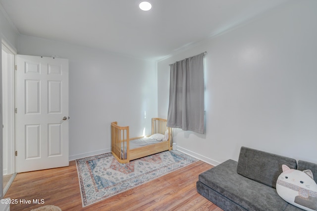 living area featuring baseboards and wood finished floors