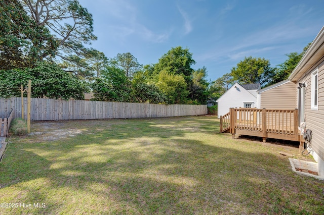 view of yard with a deck and fence