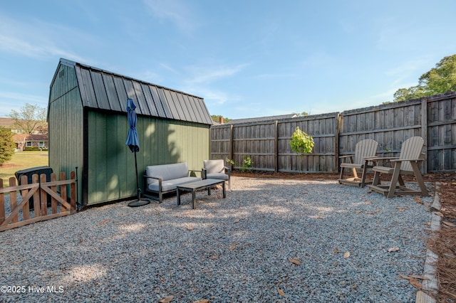 view of yard with a fenced backyard, an outdoor structure, and a shed