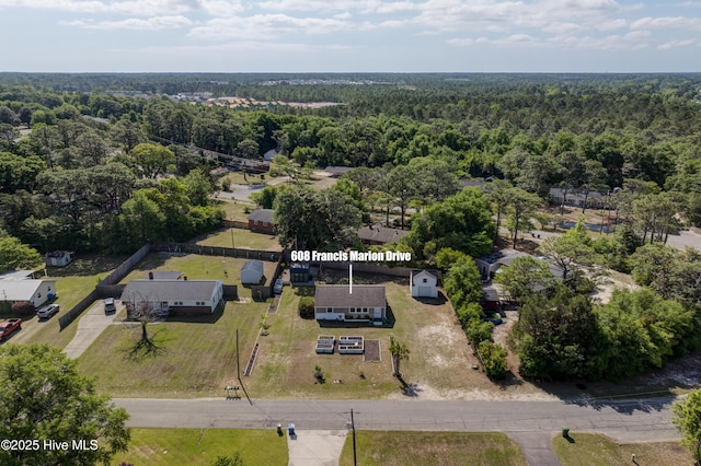 drone / aerial view with a wooded view