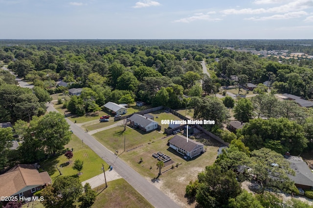 drone / aerial view with a forest view and a residential view