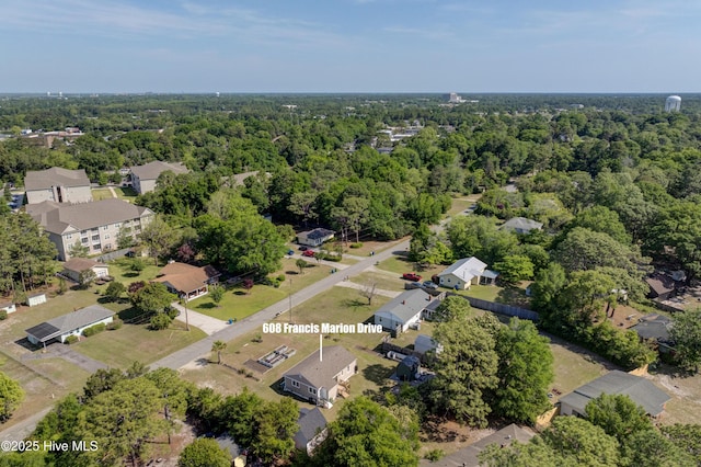 bird's eye view featuring a wooded view and a residential view