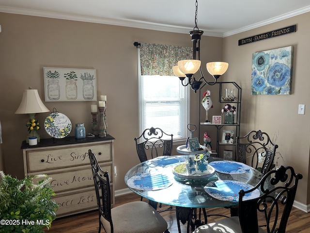 dining space featuring baseboards, dark wood-type flooring, an inviting chandelier, and crown molding