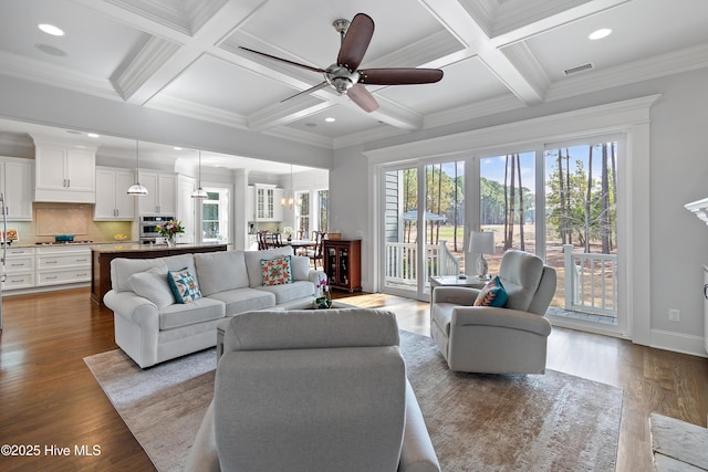 living room featuring wood finished floors, beam ceiling, and a healthy amount of sunlight