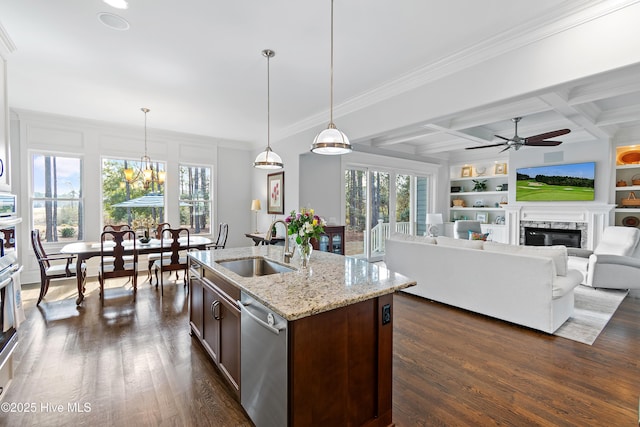 kitchen featuring dark wood-type flooring, coffered ceiling, a sink, built in features, and appliances with stainless steel finishes