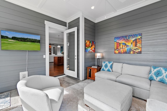 living room featuring wood finished floors and crown molding