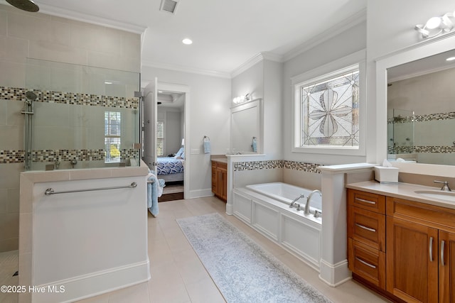 ensuite bathroom with a walk in shower, plenty of natural light, tile patterned floors, and crown molding