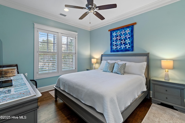 bedroom with wood finished floors, a ceiling fan, visible vents, baseboards, and ornamental molding