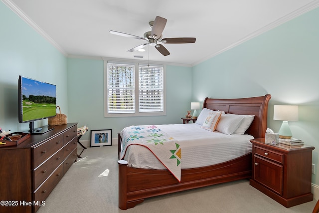 bedroom featuring visible vents, a ceiling fan, crown molding, and light colored carpet