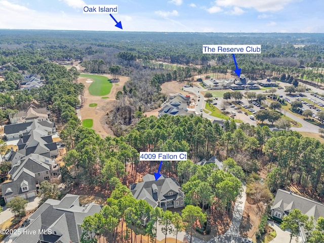 aerial view featuring a forest view and a residential view