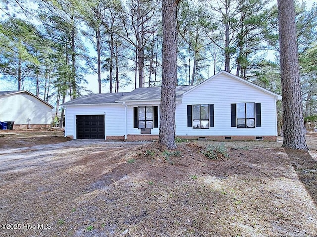 ranch-style home with a garage, crawl space, and dirt driveway