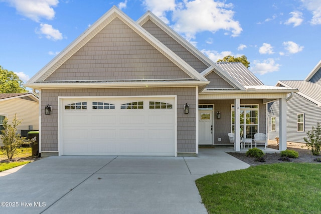 view of front of home featuring driveway, covered porch, and an attached garage