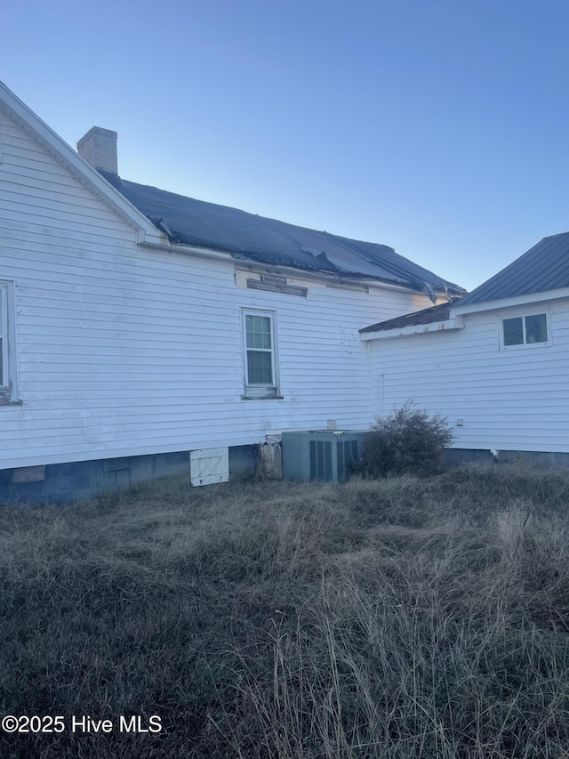 view of property exterior with central AC