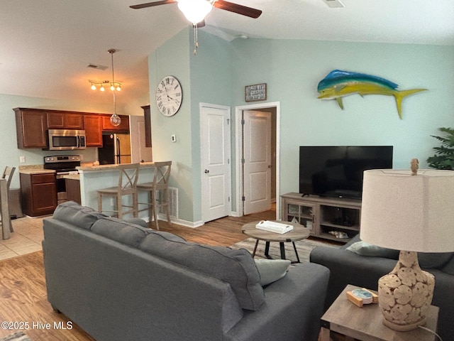 living room with a ceiling fan, light wood-type flooring, and visible vents