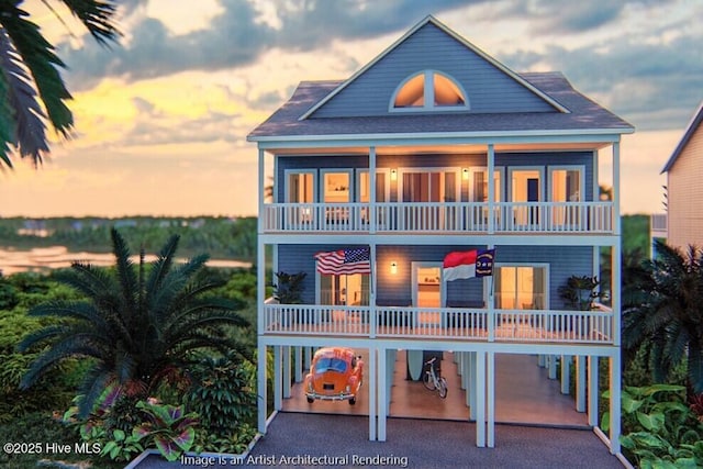 view of front of house featuring a balcony, driveway, and a carport