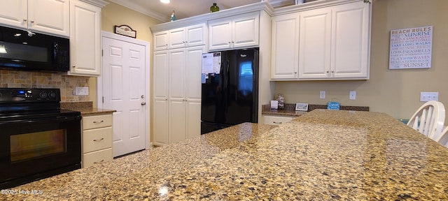 kitchen featuring black appliances, white cabinetry, light stone counters, and crown molding