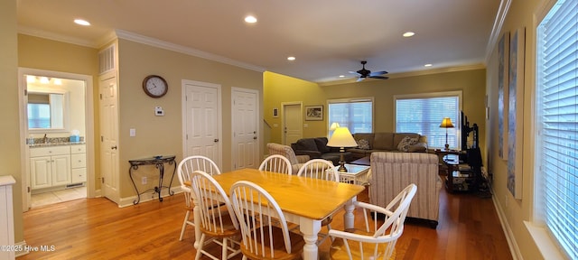 dining area featuring ornamental molding, recessed lighting, and light wood-style floors