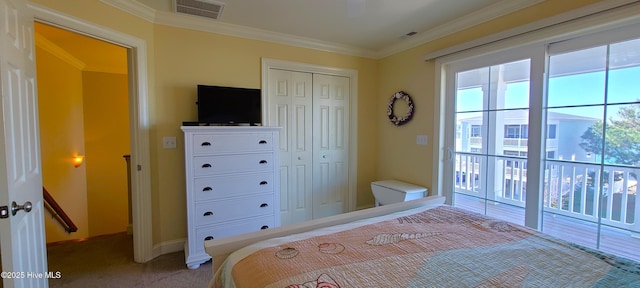 carpeted bedroom featuring ornamental molding, a closet, visible vents, and baseboards