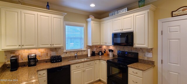 kitchen with a sink, white cabinetry, light stone countertops, black appliances, and crown molding
