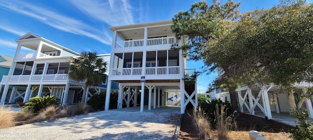 coastal inspired home with driveway and a carport