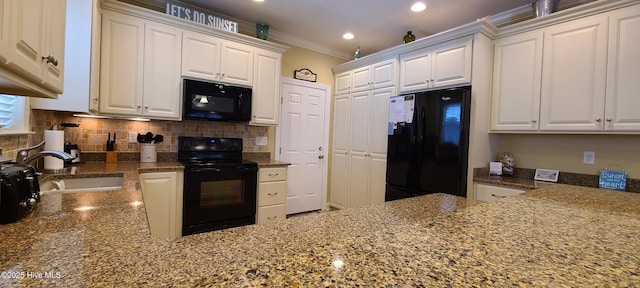 kitchen with ornamental molding, white cabinetry, a sink, and black appliances