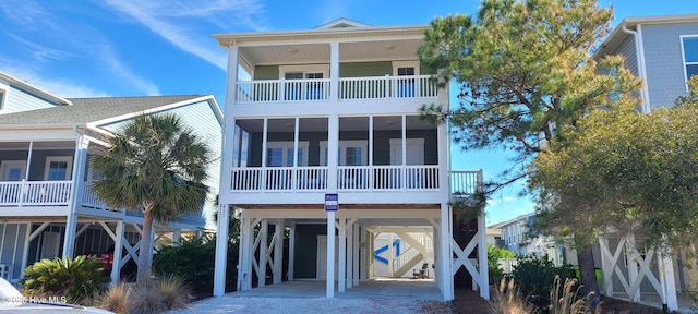 coastal home with driveway and a carport