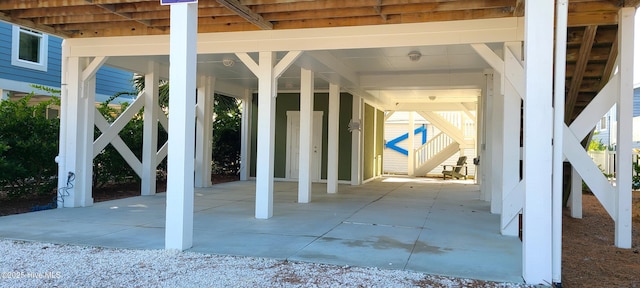 view of patio / terrace with gravel driveway and an attached carport