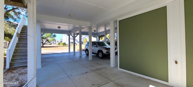 view of patio / terrace featuring a carport and stairway