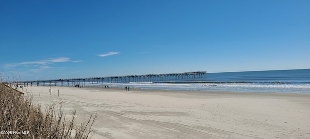 view of water feature with a pier and a view of the beach