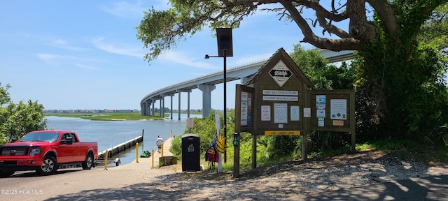 exterior space featuring a dock and a water view