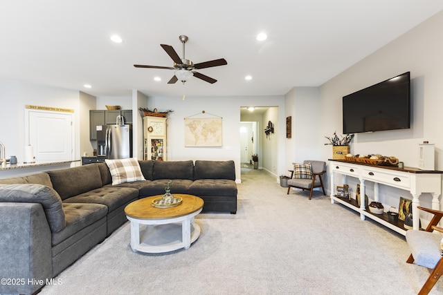 living area with light carpet, ceiling fan, and recessed lighting