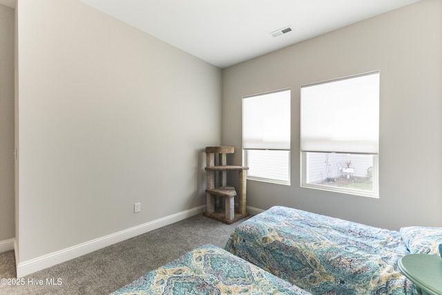 bedroom with carpet, visible vents, and baseboards